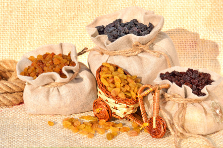 Assorted raisins in the bags on the sacking backgroundの写真素材