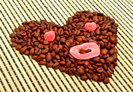 Coffee heart with jellies on bamboo matの写真素材
