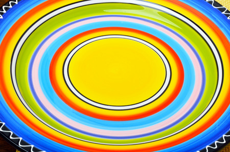 Colored plate on wooden background.の写真素材