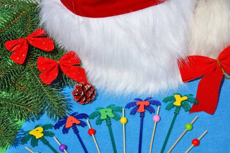 Santa Claus hat on a branch of spruce and toys opposite the pool.の写真素材