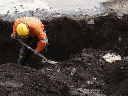   man working street sewer reconstruction of post earthquake Talcahuano Chile                            のeditorial素材