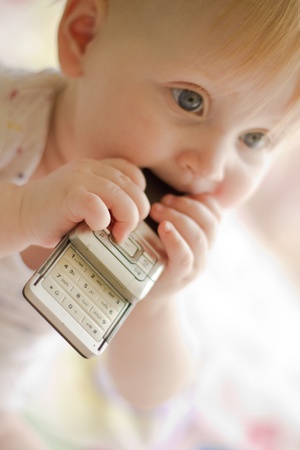 Portret of little  girl with phoneの写真素材