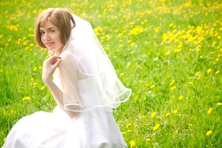 Beautiful young bride on meadowの写真素材