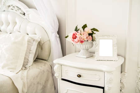 Photo frame with a white background in the interior of the bedroom.の写真素材