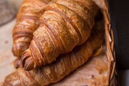 Fresh croissants on parchment paper. Crispy croissant