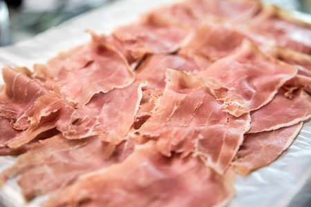 Sliced fresh pork jamon on a plateの写真素材
