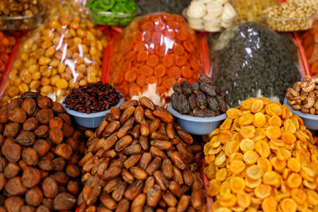 A counter with different delicious dried fruits on the marketの写真素材