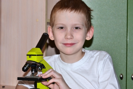 The boy looks in a microscopeの写真素材