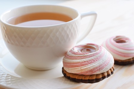 The cup of tea with sweet cookies on the saucerの写真素材