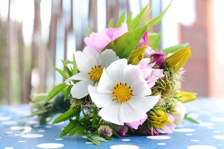 Small bouquet of different colored flowers on the table indorsの写真素材