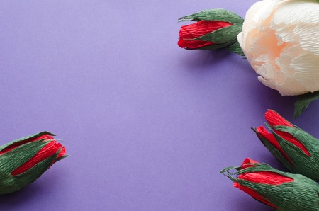 artificial peony and roses flowers over ulrtaviolet paper texture background, copy spaceの写真素材