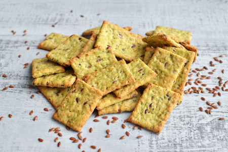 Dry italian bread snack with flax seeds over bright wooden background, top viewの写真素材