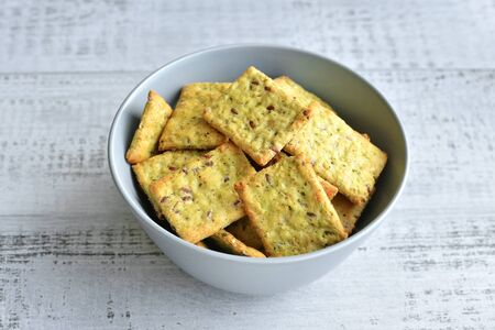 Dry italian bread with spices in ceramic bowl over wooden backgroundの写真素材