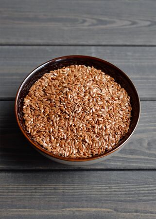 flax seeds in bowl on table backgroundの写真素材