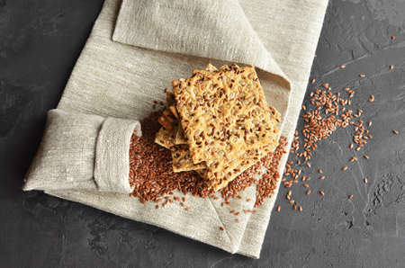 Multigrain cookies with flax seed, sunflower seeds and sesame. Stack of crispbread with flax seeds...