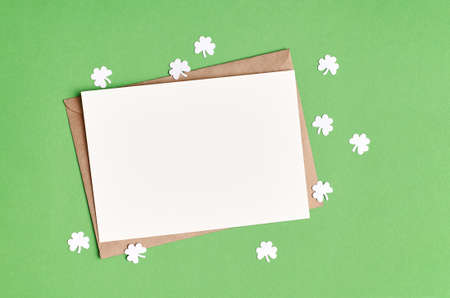 Saint Patricks day greeting card mockup with paper shamrock on green background, copy spaceの写真素材