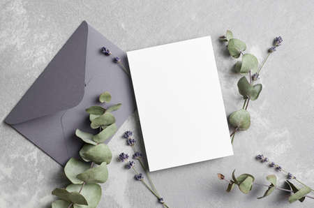 Greeting or wedding invitation card mockup with envelope, lavender and dry eucalyptus twigsの写真素材