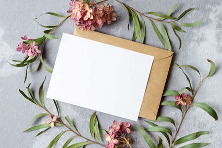 Wedding invitation or greeting card with empty space mockup with envelope and dry trendy flowers...