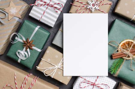 Christmas greeting card mockup flat lay with festive decorated gifts