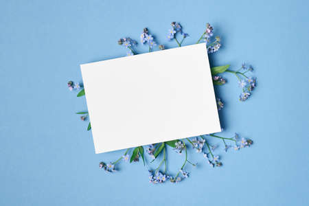 Wedding invitation or greeting card mockup with forget-me-not flowersの写真素材
