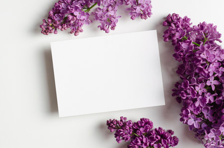 Wedding invitation card mockup with spring lilac flowers, floral layout with empty cardの写真素材