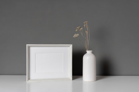 Landscape blank frame mockup with dry flowers in vaseの写真素材