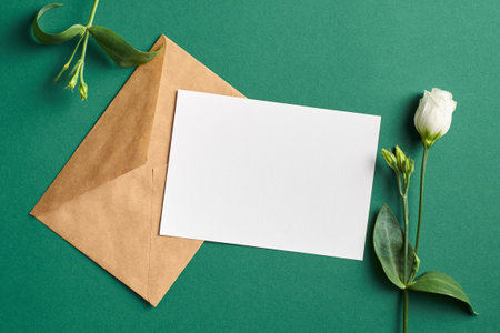 Invitation or greeting card mockup with envelope and white eustoma flowers, blank card with copy spaceの写真素材