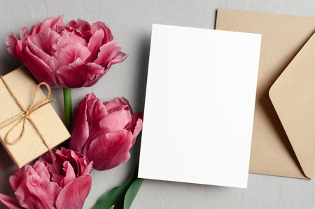 Blank greeting card mockup with envelope, gift box and pink peony flowers, valentines day greeting card mockupの写真素材