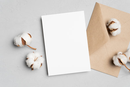 Invitation card mockup with cotton flowers and envelope, blank card with copy spaceの写真素材