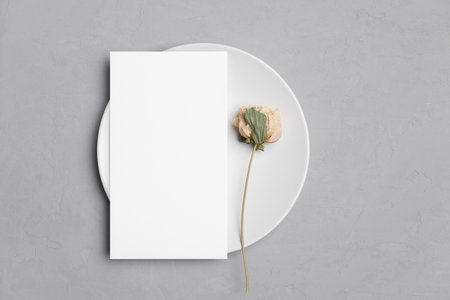 Wedding paper blank menu card mockup on white plate with copy spaceの写真素材