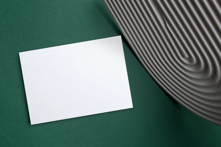 Blank invitation card mockup in minimalistic style on green backgroundの写真素材