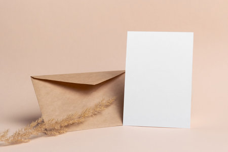 Blank invitation card mockup with craft envelope and botanical decor, blank card with copy spaceの写真素材