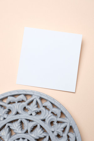 Blank trendy invite card mockup with copy space on beige background, top viewの写真素材