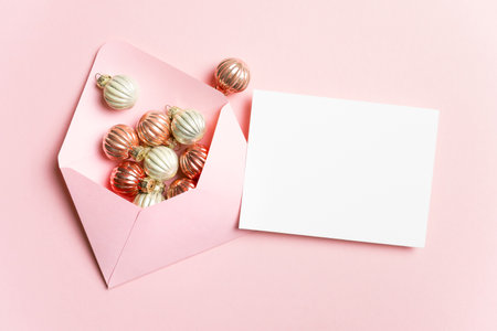 Christmas card mockup with pink envelope and winter holidays decorations, copy space