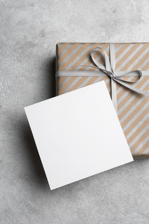 Blank square fathers day or birthday paper card mockup with gift box, copy space for card design, top viewの写真素材