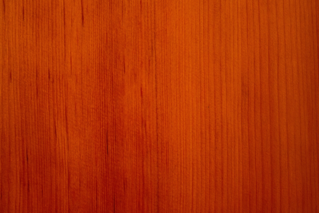 Wooden background with a natural pattern. Thin vertical veins. Warm yellow and brown shades. The varnished surface.の写真素材