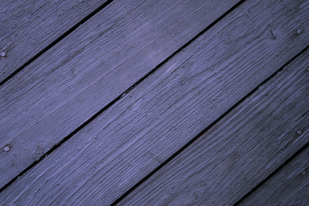 Old, worn boards on a diagonal. A faded lilac color. Sheathing of the house. Natural wood.の写真素材