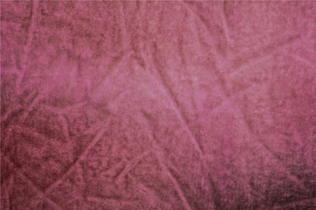 Ancient pink velvet. Wiped, wrinkled cloth. A vintage, badly worn thing. Pink, burgundy and crimson shades. Uneven coloring.の写真素材