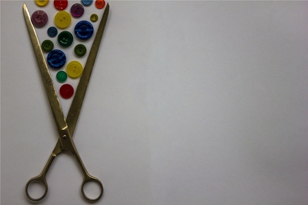 Individual tailoring. Scissors for cutting fabrics and various buttons for clothes. Sewing...