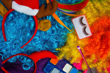 Wigs of bright colors, make-up, artificial eyelashes, decoration on the head. Preparation for the New Year's Eve.の写真素材