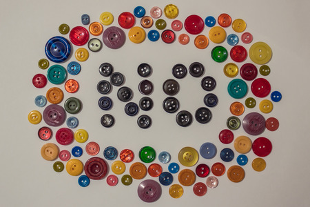 Refusal of joys of life, negative, depression. A colorful background of different buttons for clothes, in the middle the word "no". View from above.の写真素材