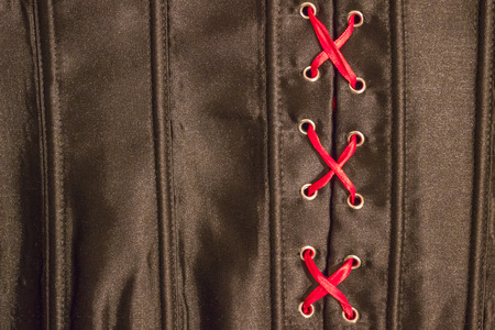 Women's underwear made of black silk. Close-up of red lacing. Mystery, forbidden topic, vicious...