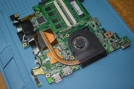 The inside of the old laptop. Determination of the cause of failure, replacement of fuses, installation of spare parts. View from above.の写真素材