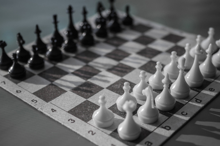 A game of chess, the initial stage. Evaluation of the enemy, waiting for the first move. Opponent, counterpart, the other side. Black and white colors, daylight.の写真素材