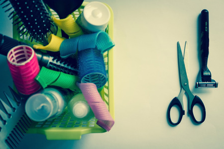 Hair curlers and combs for hair, on the one hand, and razors and scissors, on the other. Long hair and baldness, romance and practicality, complexity and simplicity.の写真素材