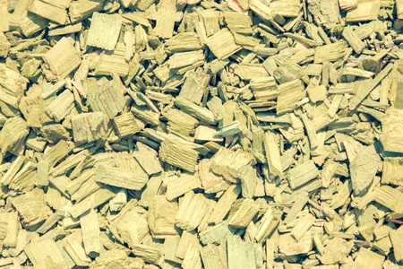 Quiet wooden background, large chips. View from above, bright sunlight, muted colors.