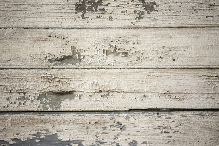 Old boards covered with light paint. Anomaly, repair is needed. Horizontal stripes. Wooden house, a fence, a wall. Daylighting, vignetting.の写真素材