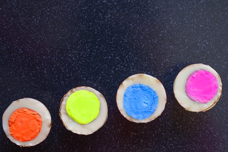 The boiled eggs have a middle of different colors. Each of us is an individual. Distinguish yourself, stand out! Dark background, top view.の写真素材