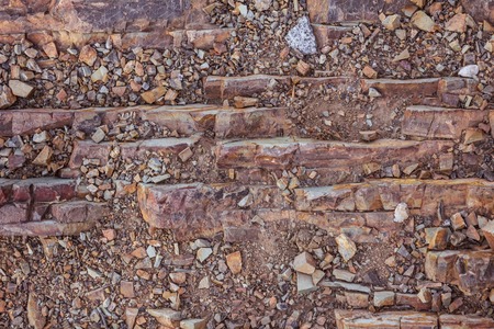 Rock, layered structure, warm brown, yellow, orange shades. Natural stone, a fragment of the...