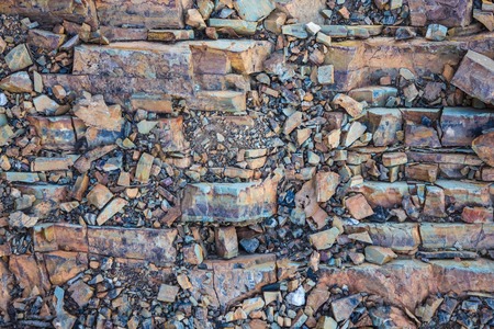 Natural rock, part of the landscape. Abstraction, lack of pattern. Small and large fragments. Purple...